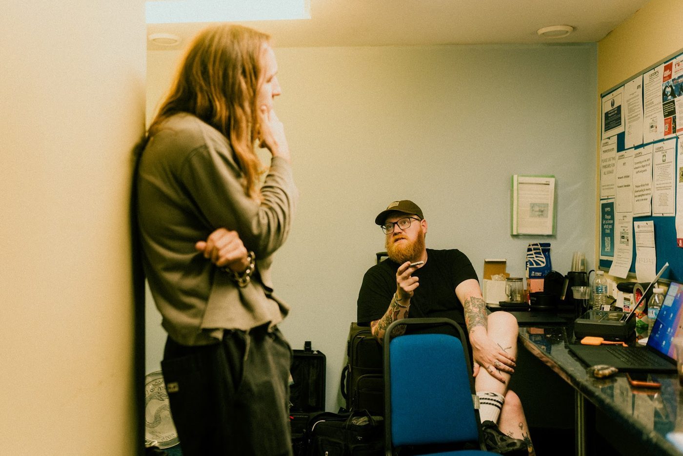 Tour manager talking with an artist in a dressing room